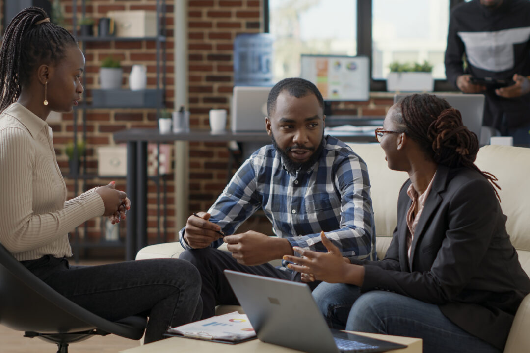 Team of business people collaborating to plan financial strategy, doing teamwork to create sales report on laptop. Office employees working on project strategy to analyze career growth.