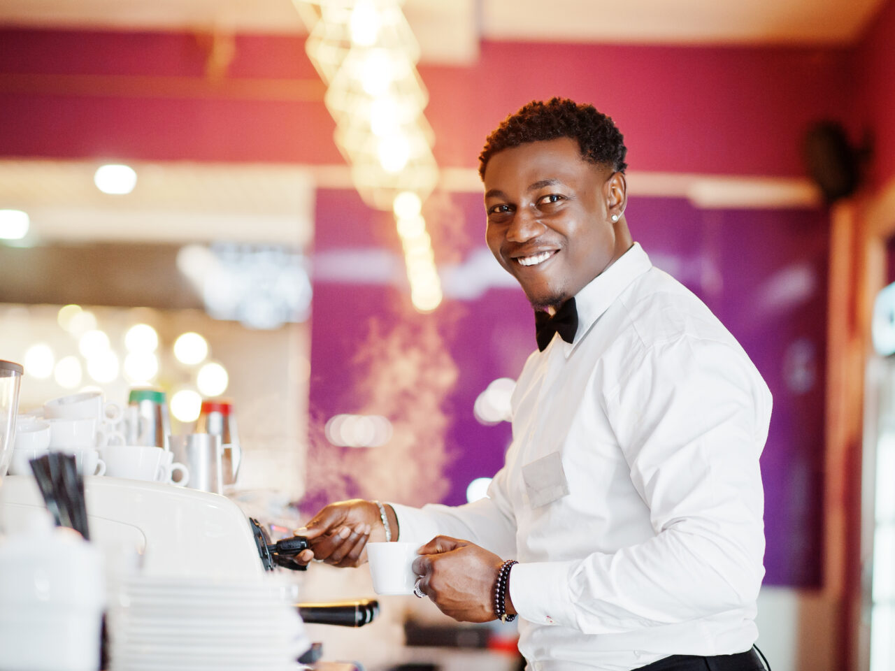 African american bartender barista at bar preparing coffee. African american bartender barista at bar preparing coffee.